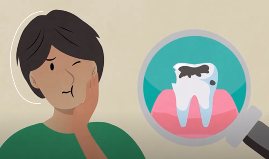 A boy puts hand to his cheek signaling that he has a toothache.